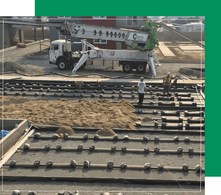 A construction site with workers and machinery on the ground.