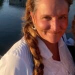 A woman with long hair and a white shirt