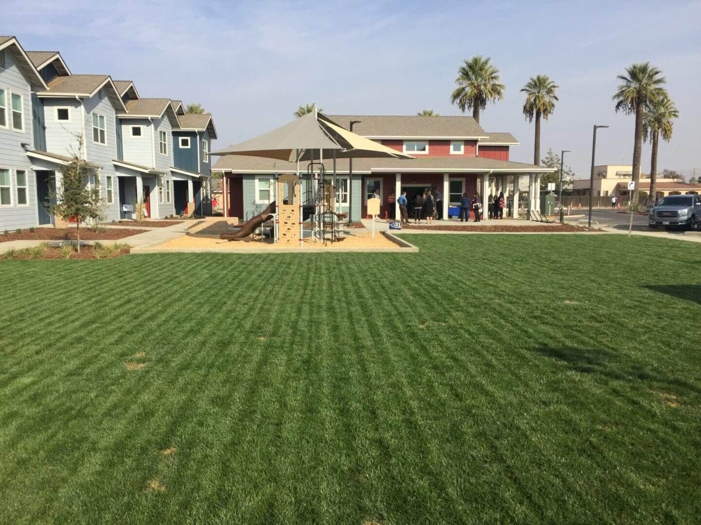 Modern homes with playground and landscaped lawn.